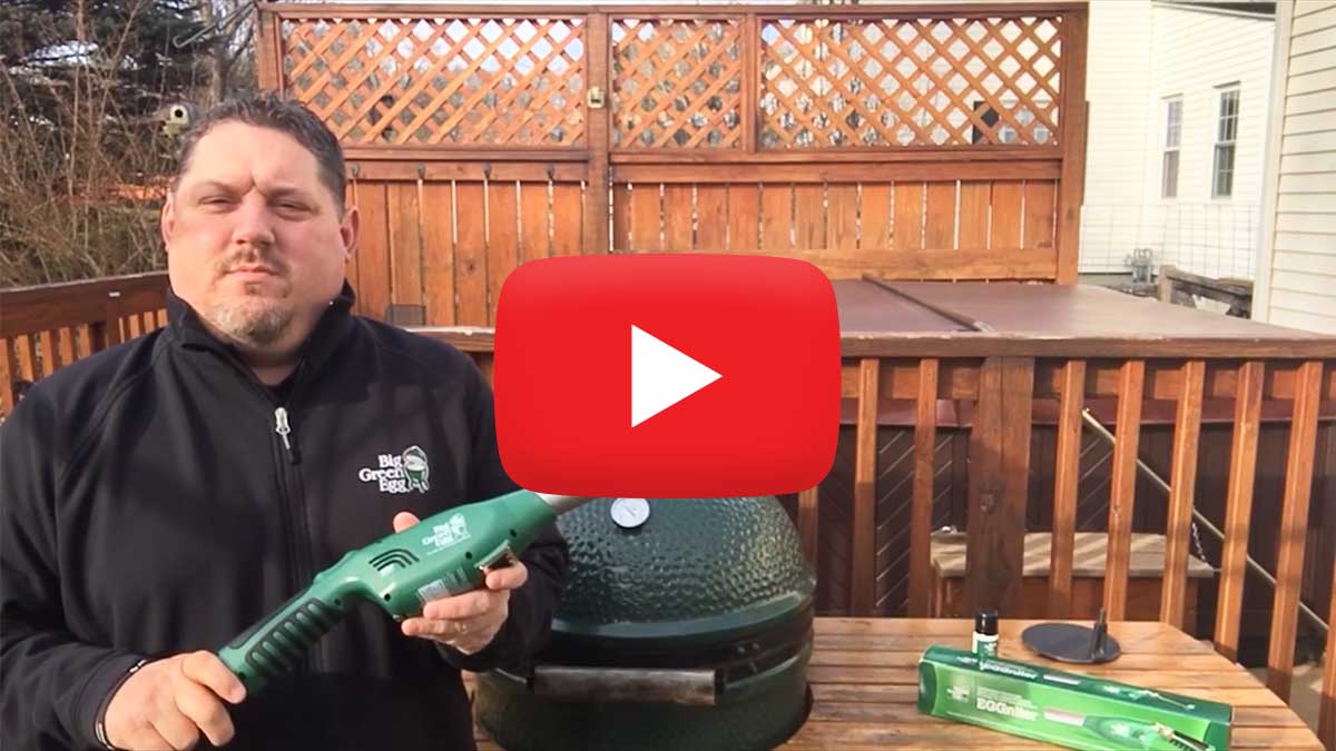 Jay Collins holding eggniter in front of Big Green Egg