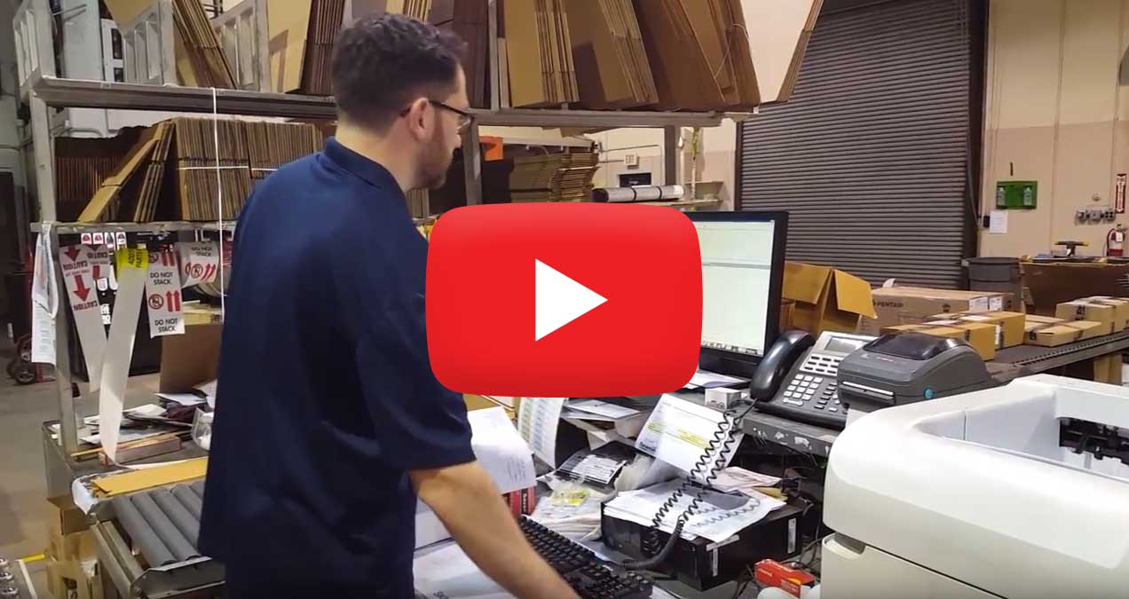 Warehouse worker using a computer.